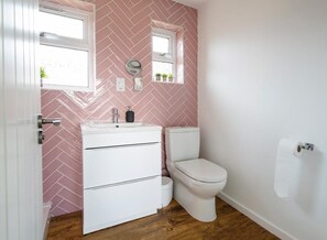 The modern bathroom with WC, sink and shower
