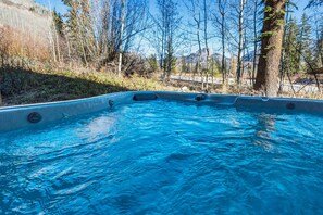 The private hot tub is located on the ground floor patio adjacent the 3rd and 4th bedrooms - Enjoy views of Spud Mountain from the hot tub in winter