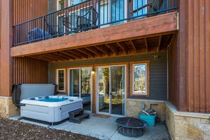 The private hot tub is located on the ground floor patio adjacent the 3rd and 4th bedrooms - Enjoy views of Spud Mountain from the hot tub in winter