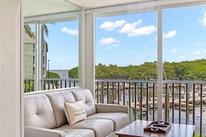 View from enclosed lanai, overlooking marina and bay