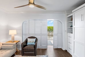 Lanai plantation shutters can be shut to function as a quasi-bedroom, featuring its own sleeper sofa and TV