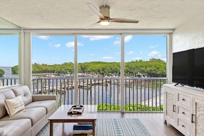 View from enclosed lanai, overlooking marina and bay