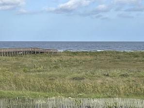 Dunes and beach are directly in front of building.