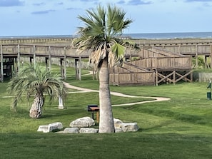 Fire pit, charcoal grill, beach access and beach club are steps away from unit.