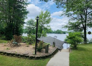 View from the patio walking toward the lake and boathouse.