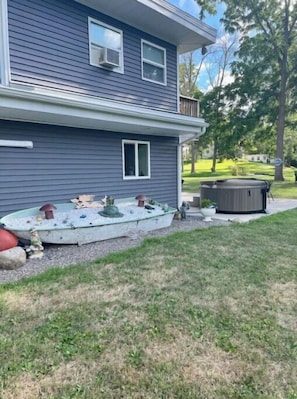 Side of home canal side; hot tub on patio