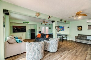 Large gameroom with TV area, lots of seating, ping pong table and queen futon
