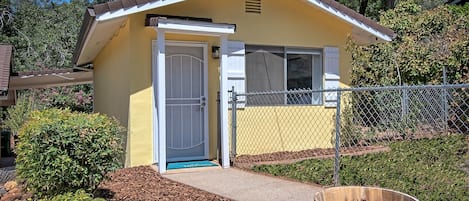 Front of cottage with fenced front yard