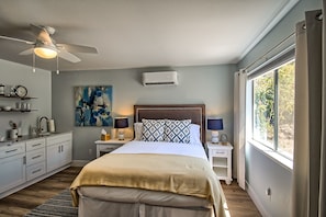 Queen bed with kitchenette & mini split overhead