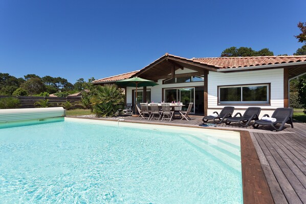Have fun splashing around in the outdoor pool by your villa!