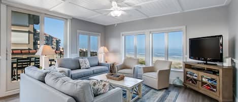Spectacular Oceanfront Views from this Sunny Sea Dunes End Unit! Living Space with 2 Sofas, Swivel Glider Chairs, Flat Screen Smart TV and Balcony Access