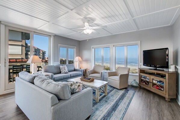 Spectacular Oceanfront Views from this Sunny Sea Dunes End Unit! Living Space with 2 Sofas, Swivel Glider Chairs, Flat Screen Smart TV and Balcony Access