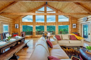 Bask in stunning mountain views while lounging by the fireplace and watching TV!