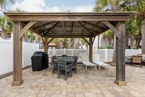 Shaded lounge, dining, and BBQ area.