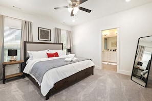 Our primary bedroom is complete with a King-size bed, closet, 55-inch TCL Roku TV and stunning en suite bath.