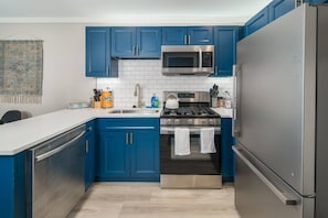 Updated well stocked kitchen with stainless steel appliances