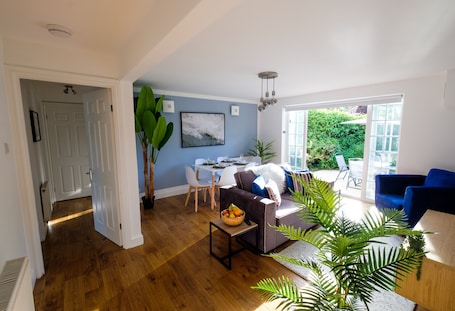 The living/dining area opens out on to a terrace with outdoor dining furniture, a BBQ/grill, and a secluded, fully enclosed private garden for the exclusive use of our guests.