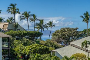 Enjoy a subtle ocean view from your cozy outdoor dining space for three.