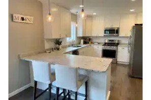 Additional breakfast bar seating with plenty of counter space for cooking