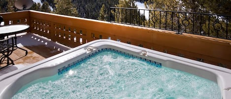 Soak sore muscles in the private outdoor hot tub after a day on the mountain.