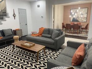 Open Living/Dining area with Large Smart TV