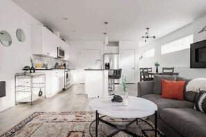 Living area and kitchen with dining spaces