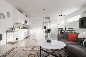 Living area and kitchen with dining spaces