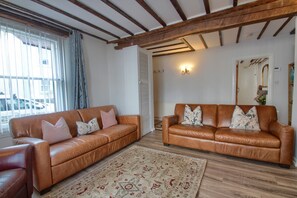 The spacious living room has lovely period features