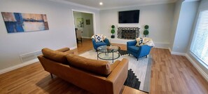Spacious living area with fireplace and big screen Smart TV