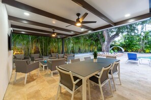 Covered terrace with a dining table.