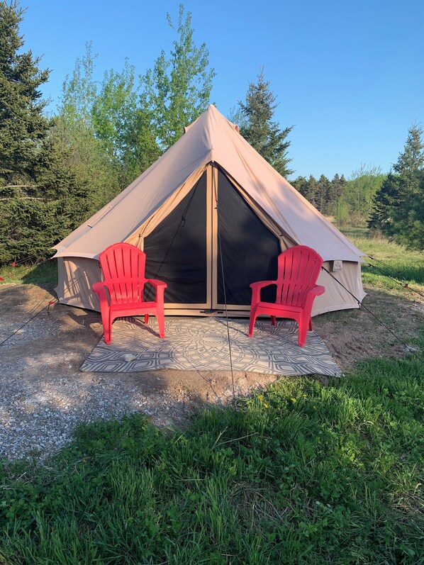 200 square foot bell tent with queen sized bed and all the camping supplies
