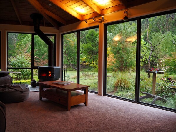 Relax by the inside fire and enjoy watching your private garden
