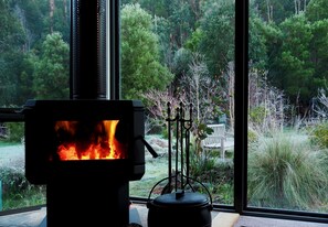 Cozy wood-burning fireplace with soft glow, perfect for relaxing afternoons