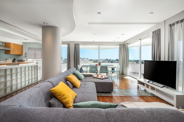 Open space living room with panoramic sea view (old sofa)