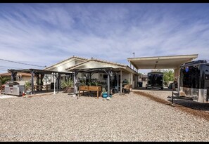 Fenced back yard. Grill, brick fire pit, misters, covered patio, room to relax