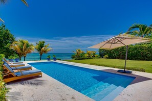 Oceanfront views with pool area, garden, and outdoor furniture