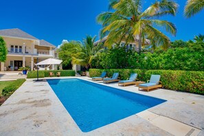 Oceanfront views with pool area, garden, and outdoor furniture