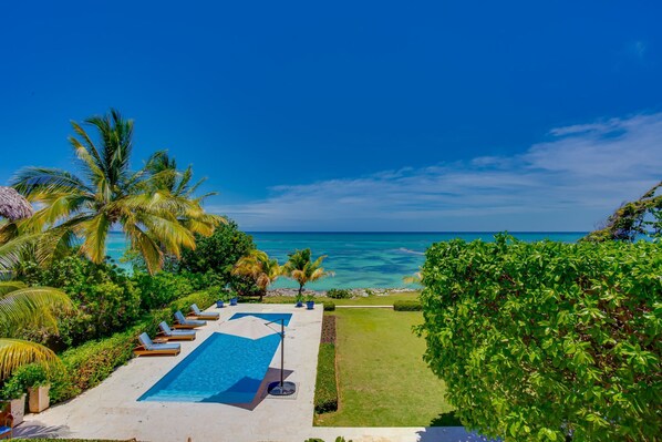 Oceanfront views with pool area, garden, and outdoor furniture