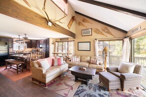 Spacious living room area with gas powered fire place, 65" Smart Tv and AppleTV