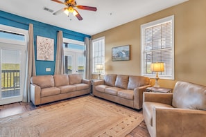 living room with queen sofa sleeper, smart tv and deck access