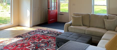 View of great room entrance door, celing fan, high window exposed to North light