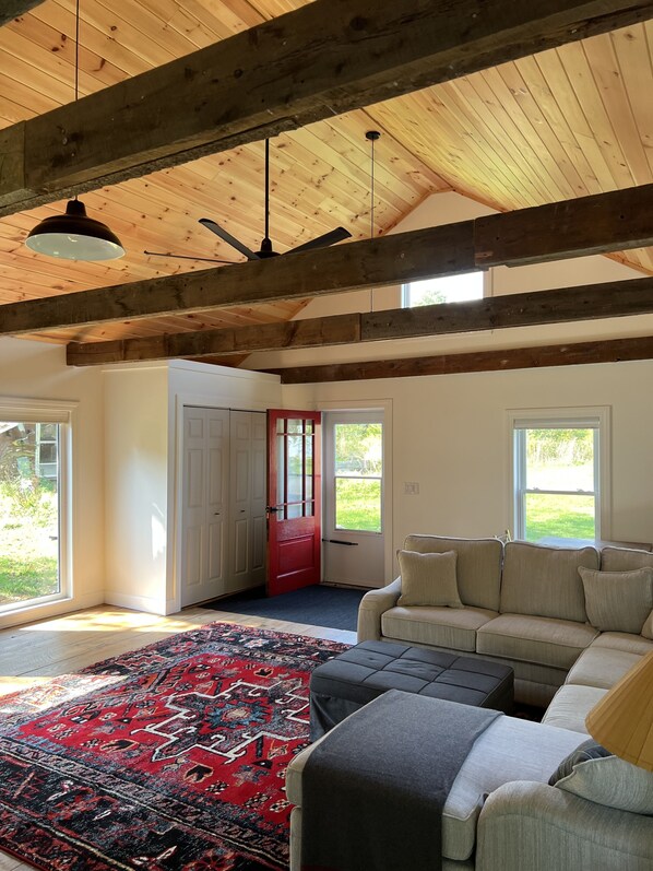 View of great room entrance door, celing fan, high window exposed to North light