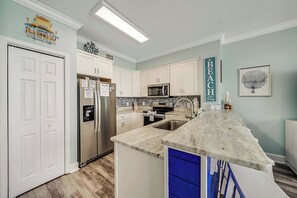The fully equipped kitchen features granite countertops, stainless-steel appliances, and has everything you need to prepare meals for family & friends.
