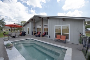 Back patio w/spa pool (8' x 18', 3'6" to 4'6" deep). Heated with iPhone app only