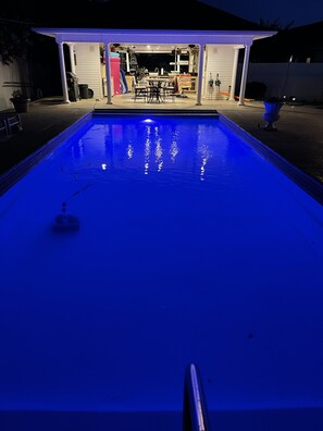 Evening view of pool with automatic pool cleaner