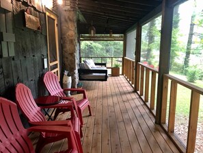 Screen in porch with plenty of seating space and area to relax.