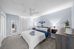 King bed, soft lighting, and a lighted mirror create a peaceful, luxe retreat.
