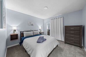 Inviting bedroom with plush queen bed, soft lighting, and a calm, restful vibe.