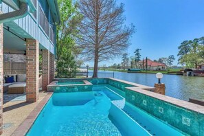 Take a splash in the private pool and spa overlooking the lake 