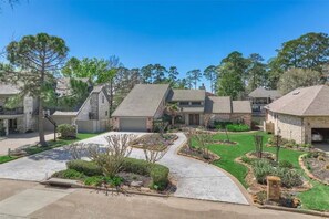 Large driveway and lush landscaping 